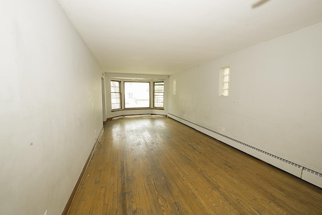 4033 N Austin Ave, Chicago, IL 60634 - empty room with a baseboard radiator, wood-type flooring, and baseboards