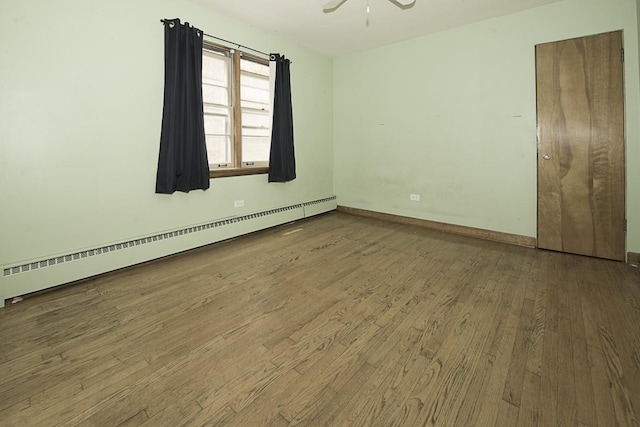 4033 N Austin Ave, Chicago, IL 60634 - empty room with a baseboard heating unit, wood finished floors, ceiling fan, and baseboards
