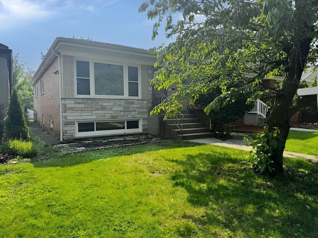 5349 N Meade Ave, Chicago, IL 60630 - view of property exterior with a lawn, stairway, stone siding, and brick siding