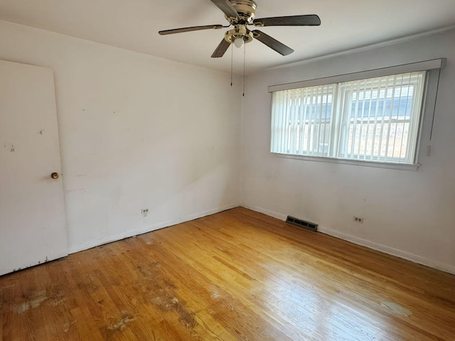 5349 N Meade Ave, Chicago, IL 60630 - spare room featuring wood finished floors, ceiling fan, and baseboards