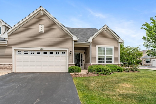 552 Autumn Cir, Pingree Grove, IL 60140 - view of front of house featuring a front lawn, asphalt driveway, brick siding, and a shingled roof