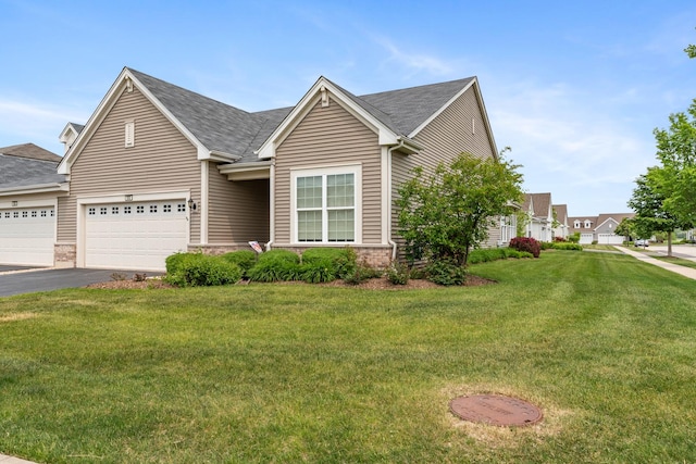 552 Autumn Cir, Pingree Grove, IL 60140 - view of front of home with driveway, a front yard, brick siding, and roof with shingles
