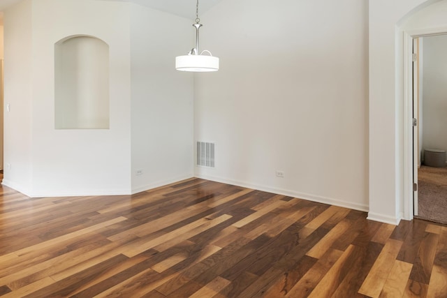 552 Autumn Cir, Pingree Grove, IL 60140 - unfurnished dining area featuring arched walkways, wood finished floors, and baseboards