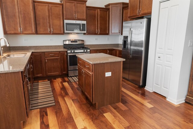 552 Autumn Cir, Pingree Grove, IL 60140 - kitchen with appliances with stainless steel finishes, a sink, dark wood-style floors, and light stone counters