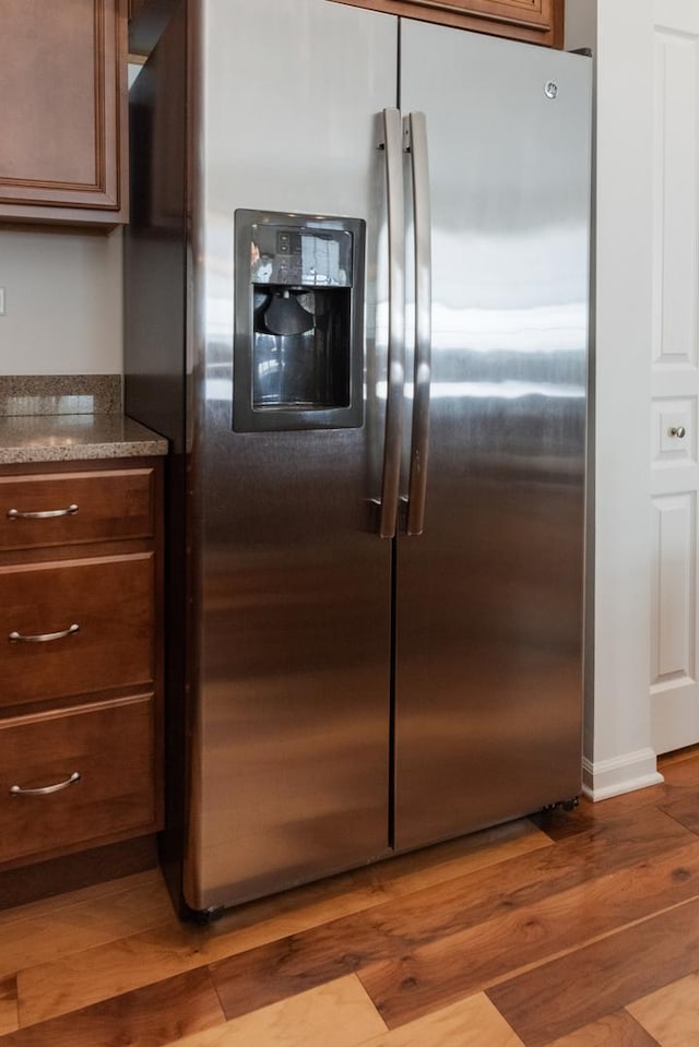 552 Autumn Cir, Pingree Grove, IL 60140 - kitchen with stainless steel fridge, wood finished floors, and dark stone counters