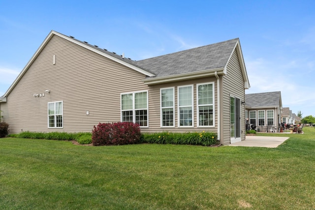 552 Autumn Cir, Pingree Grove, IL 60140 - view of side of property with a patio area, a shingled roof, and a yard