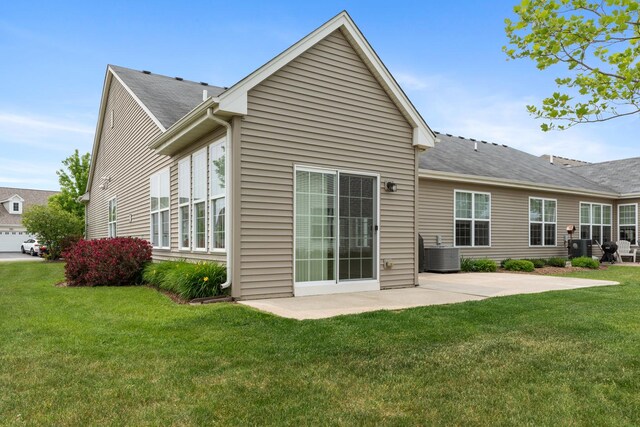 552 Autumn Cir, Pingree Grove, IL 60140 - back of house featuring a patio area, a lawn, central air condition unit, and a shingled roof