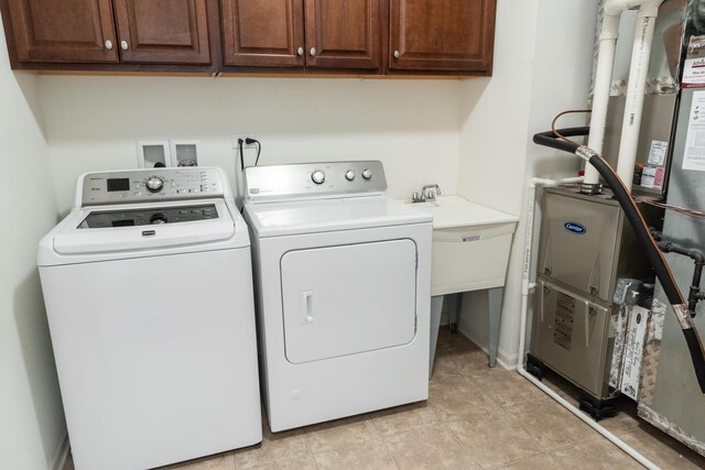 552 Autumn Cir, Pingree Grove, IL 60140 - laundry room featuring washer and clothes dryer, cabinet space, and light tile patterned flooring