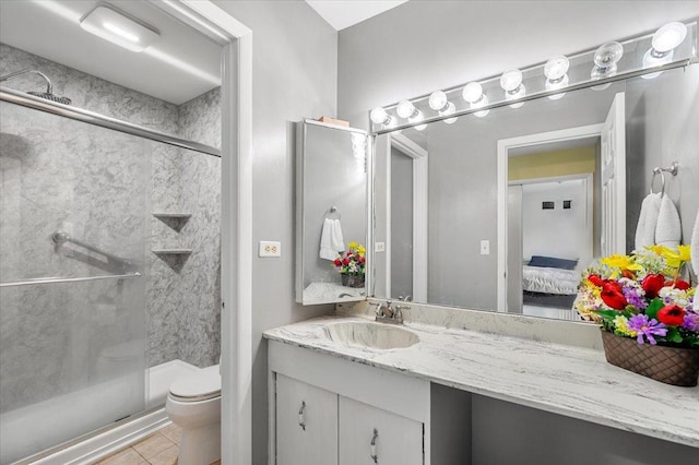 642 Dunham Rd, Gurnee, IL 60031 - bathroom featuring a stall shower, toilet, vanity, tile patterned floors, and connected bathroom