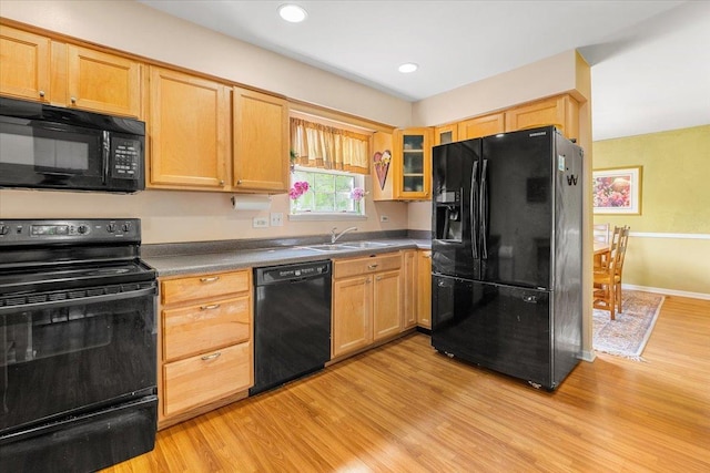 642 Dunham Rd, Gurnee, IL 60031 - kitchen featuring black appliances, a sink, light wood-type flooring, glass insert cabinets, and dark countertops