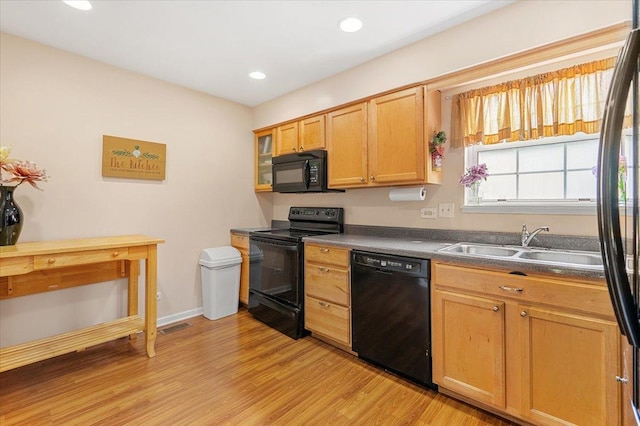 642 Dunham Rd, Gurnee, IL 60031 - kitchen featuring black appliances, light wood-type flooring, a sink, dark countertops, and recessed lighting