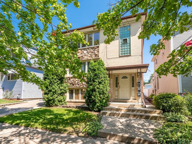 2207 N 74th Ct Unit 2, Elmwood Park, IL 60707 - view of front of home featuring brick siding and a front lawn
