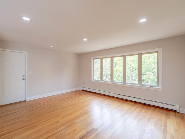 2207 N 74th Ct Unit 2, Elmwood Park, IL 60707 - unfurnished room featuring a baseboard radiator, light wood finished floors, baseboards, and recessed lighting