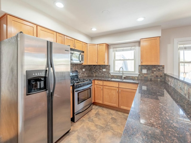2207 N 74th Ct Unit 2, Elmwood Park, IL 60707 - kitchen with stainless steel appliances, a sink, light brown cabinetry, backsplash, and dark stone counters