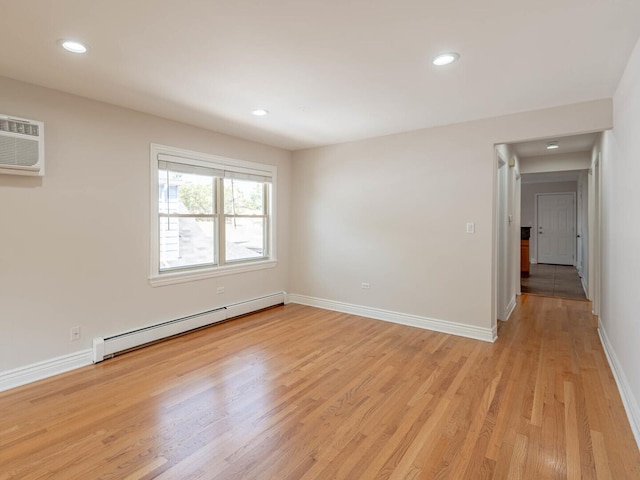 2207 N 74th Ct Unit 2, Elmwood Park, IL 60707 - empty room with a baseboard heating unit, baseboards, light wood-style floors, recessed lighting, and a wall mounted air conditioner