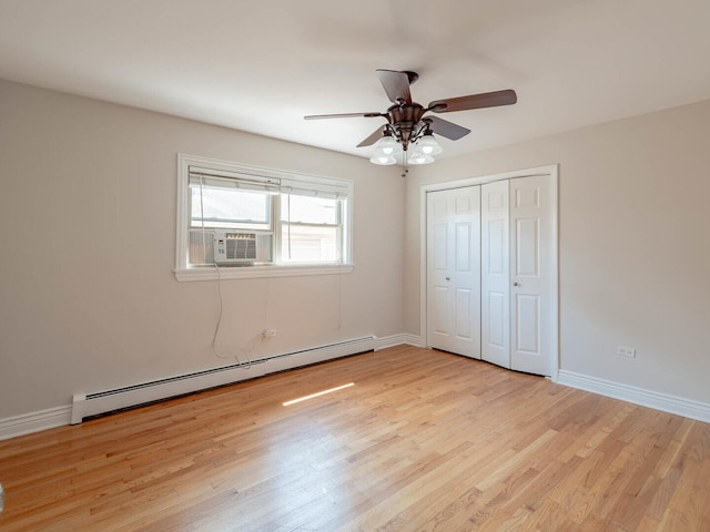 2207 N 74th Ct Unit 2, Elmwood Park, IL 60707 - unfurnished bedroom with a baseboard radiator, cooling unit, light wood-style flooring, and a closet