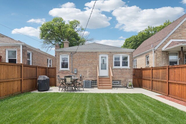 5423 S Rutherford Ave, Chicago, IL 60638 - back of house featuring entry steps, a chimney, brick siding, a fenced backyard, and a patio area