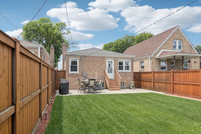 5423 S Rutherford Ave, Chicago, IL 60638 - rear view of house with entry steps, brick siding, a fenced backyard, a patio, and a shingled roof