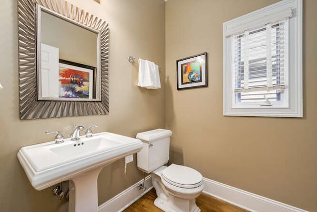 3329 N Bell Ave, Chicago, IL 60618 - bathroom featuring baseboards and wood finished floors