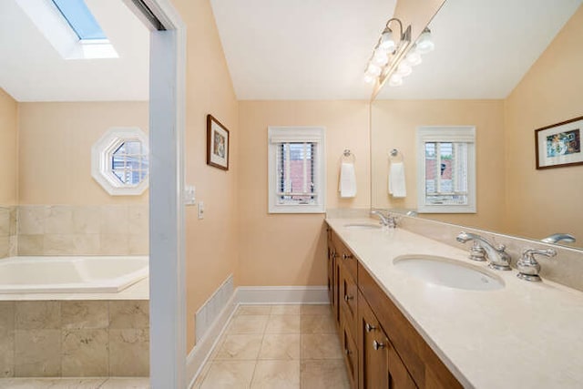 3329 N Bell Ave, Chicago, IL 60618 - bathroom with a skylight, double vanity, lofted ceiling, a bath, and tile patterned floors