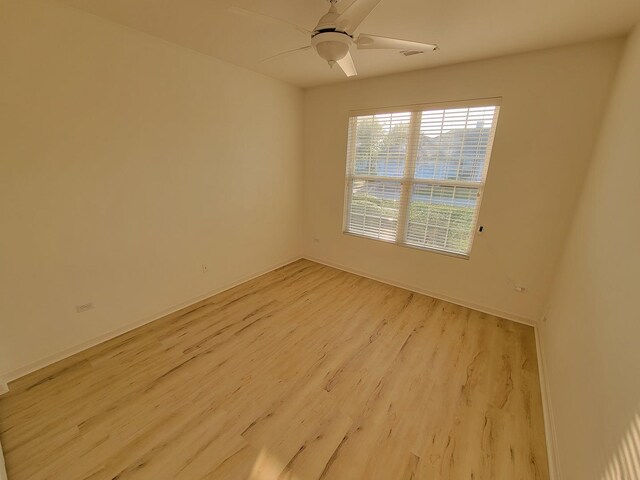13663 Whittingham Ln, Huntley, IL 60142 - spare room featuring light wood-style flooring, a ceiling fan, and baseboards