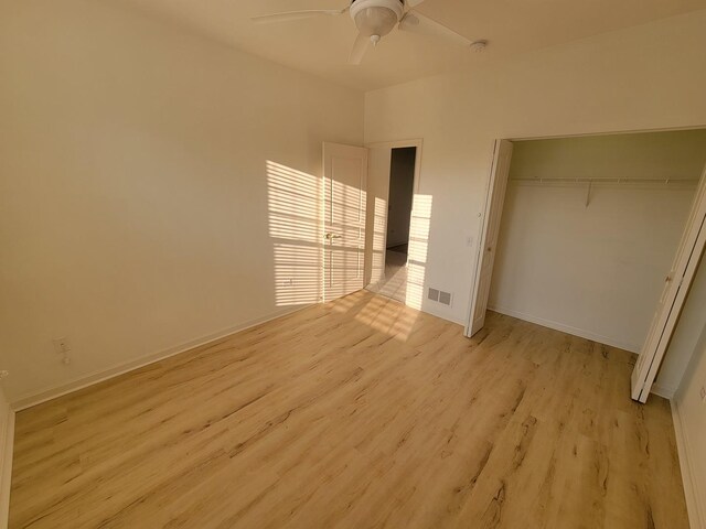 13663 Whittingham Ln, Huntley, IL 60142 - unfurnished bedroom with light wood-style flooring, a closet, baseboards, and ceiling fan