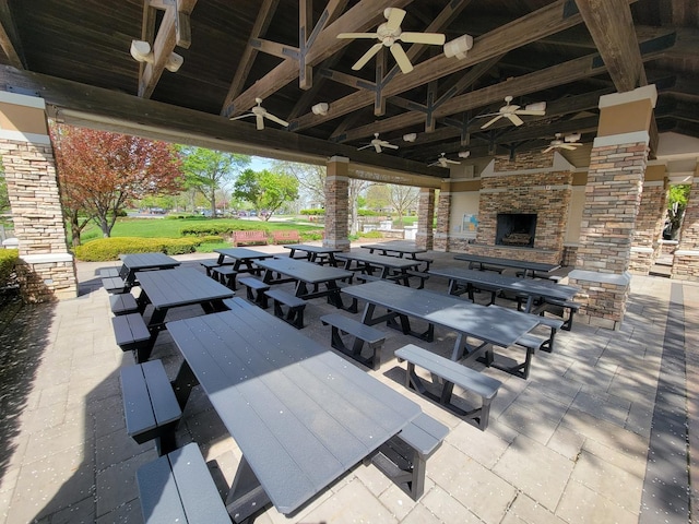 13663 Whittingham Ln, Huntley, IL 60142 - view of patio / terrace with an outdoor stone fireplace, outdoor dining space, a ceiling fan, and a gazebo