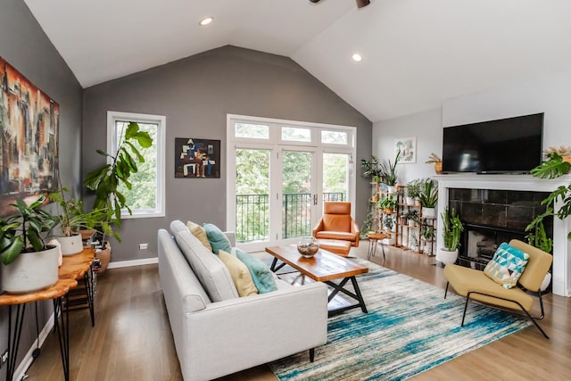 2737 W Thomas St Unit 3, Chicago, IL 60622 - living room with wood finished floors, recessed lighting, a tile fireplace, baseboards, and high vaulted ceiling