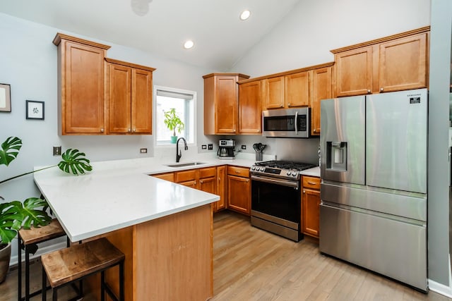 2737 W Thomas St Unit 3, Chicago, IL 60622 - kitchen with stainless steel appliances, a sink, a peninsula, a kitchen breakfast bar, and light wood finished floors
