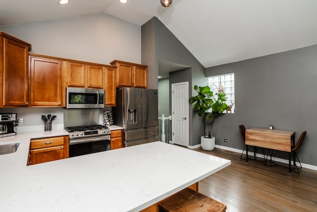 2737 W Thomas St Unit 3, Chicago, IL 60622 - kitchen with stainless steel appliances, light countertops, dark wood-style flooring, baseboards, and a peninsula