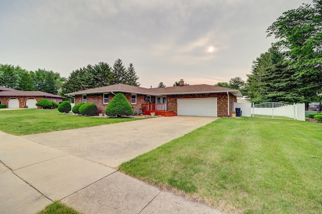 611 Marsha Ln, Rock Falls, IL 61071 - single story home featuring an attached garage, a chimney, concrete driveway, brick siding, and a gate