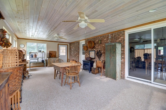 611 Marsha Ln, Rock Falls, IL 61071 - carpeted dining room with crown molding, a wood stove, wooden ceiling, brick wall, and a ceiling fan