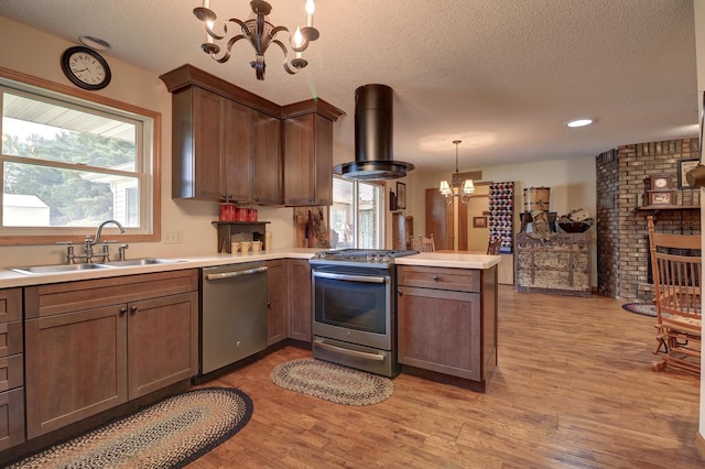 611 Marsha Ln, Rock Falls, IL 61071 - kitchen featuring appliances with stainless steel finishes, island range hood, a chandelier, a sink, and a peninsula