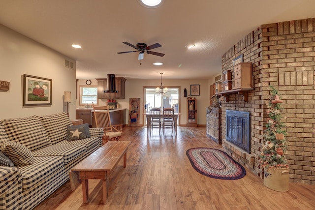 611 Marsha Ln, Rock Falls, IL 61071 - living area with wood finished floors, ceiling fan, a chandelier, a fireplace, and recessed lighting