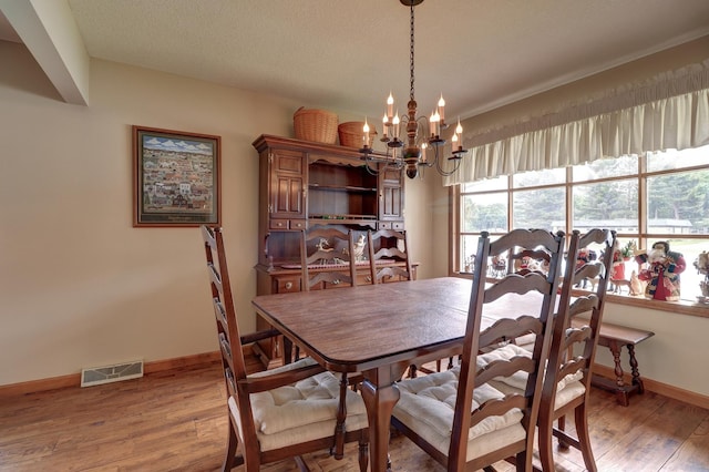 611 Marsha Ln, Rock Falls, IL 61071 - dining area featuring a chandelier, baseboards, and light wood-style floors