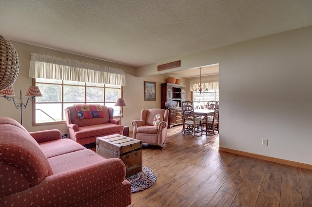 611 Marsha Ln, Rock Falls, IL 61071 - living room with a chandelier, hardwood / wood-style flooring, baseboards, and a textured ceiling
