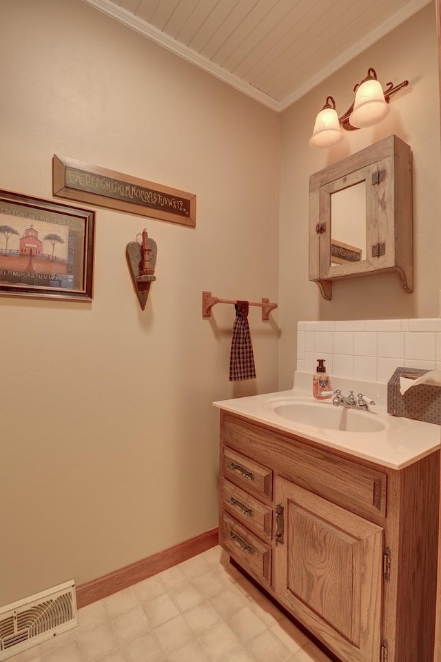 611 Marsha Ln, Rock Falls, IL 61071 - bathroom featuring vanity, ornamental molding, baseboards, tile patterned floors, and backsplash