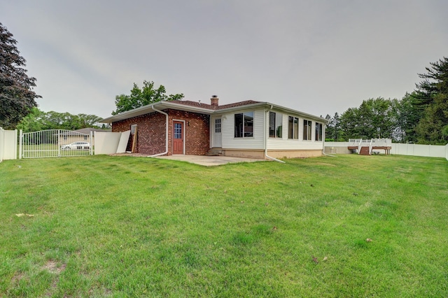 611 Marsha Ln, Rock Falls, IL 61071 - rear view of property featuring a gate, a chimney, brick siding, and a patio area