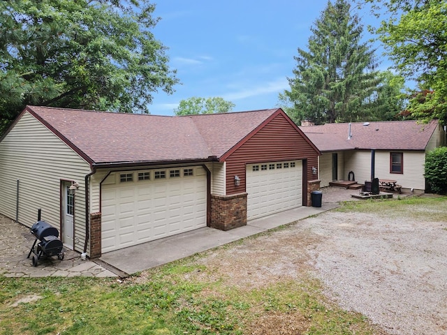 7308 W Lancaster Rd, Peoria, IL 61607 - ranch-style house featuring roof with shingles, an attached garage, brick siding, and dirt driveway