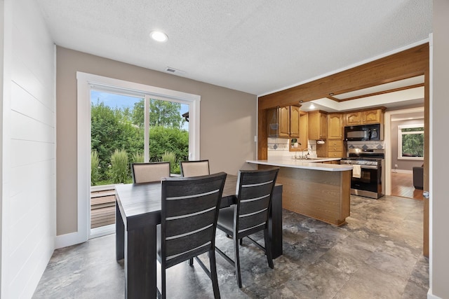 7308 W Lancaster Rd, Peoria, IL 61607 - dining room with a textured ceiling and baseboards