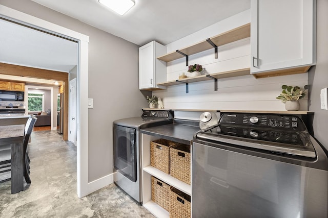 7308 W Lancaster Rd, Peoria, IL 61607 - laundry room with cabinet space, independent washer and dryer, and baseboards
