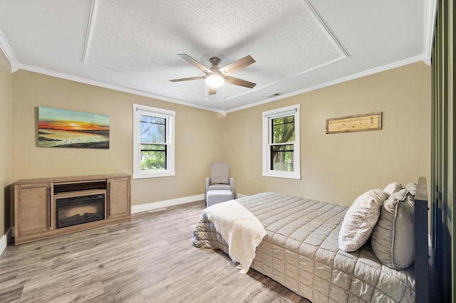 7308 W Lancaster Rd, Peoria, IL 61607 - bedroom with wood finished floors, crown molding, a textured ceiling, baseboards, and a ceiling fan
