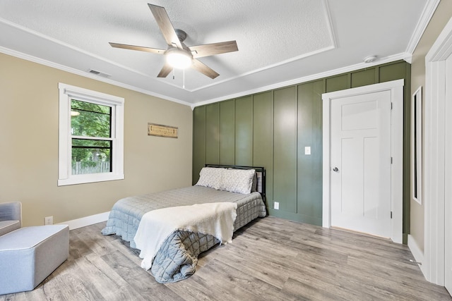 7308 W Lancaster Rd, Peoria, IL 61607 - bedroom with ornamental molding, wood finished floors, a textured ceiling, baseboards, and ceiling fan