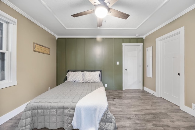 7308 W Lancaster Rd, Peoria, IL 61607 - bedroom featuring wood finished floors, a ceiling fan, ornamental molding, and baseboards