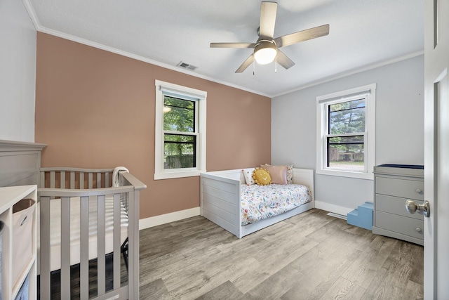 7308 W Lancaster Rd, Peoria, IL 61607 - bedroom with wood finished floors, multiple windows, crown molding, baseboards, and a ceiling fan