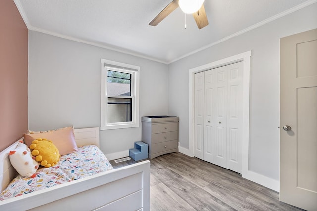 7308 W Lancaster Rd, Peoria, IL 61607 - bedroom with crown molding, light wood-style flooring, a closet, baseboards, and ceiling fan