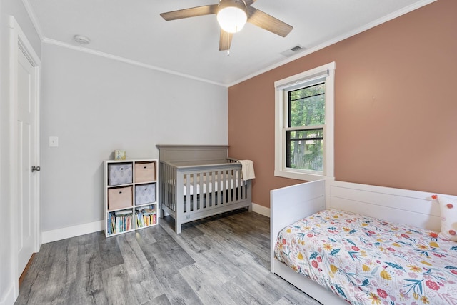 7308 W Lancaster Rd, Peoria, IL 61607 - bedroom with wood finished floors, crown molding, ceiling fan, and baseboards