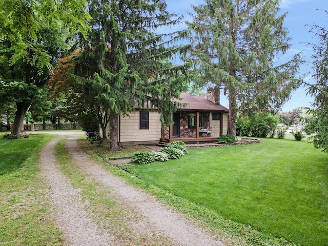 7308 W Lancaster Rd, Peoria, IL 61607 - view of front of house with a chimney, driveway, a front lawn, and a porch