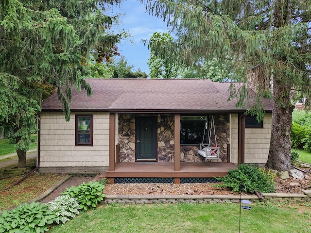 7308 W Lancaster Rd, Peoria, IL 61607 - ranch-style house featuring stone siding, a shingled roof, and covered porch