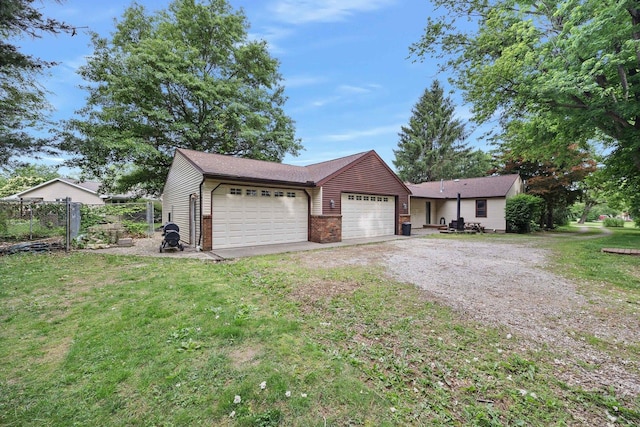 7308 W Lancaster Rd, Peoria, IL 61607 - view of front of home with driveway, a garage, and brick siding
